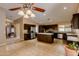Open kitchen with an island and view into living area at 12465 N 71St Ave, Peoria, AZ 85381