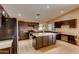 Spacious kitchen with granite countertops and dark wood cabinets at 12465 N 71St Ave, Peoria, AZ 85381