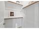White closet with wood shelving and rods at 13616 W Sandridge Dr, Sun City West, AZ 85375