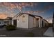 Charming stucco home with a walkway, landscaping, and two-car garage at 13616 W Sandridge Dr, Sun City West, AZ 85375