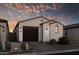 Single-story home with stucco exterior, dark brown garage door, and landscaping at 13616 W Sandridge Dr, Sun City West, AZ 85375