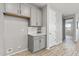Hallway with gray cabinets and access to room at 13616 W Sandridge Dr, Sun City West, AZ 85375