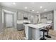 Modern kitchen with gray cabinets, white countertops, and an island at 13616 W Sandridge Dr, Sun City West, AZ 85375