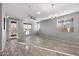 Spacious living room with wood-look floors and access to a patio at 13616 W Sandridge Dr, Sun City West, AZ 85375
