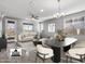 Virtually staged living room with dining area and access to a balcony at 13616 W Sandridge Dr, Sun City West, AZ 85375