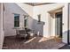 Brick patio with a bistro table and chairs near the front entrance at 13616 W Sandridge Dr, Sun City West, AZ 85375