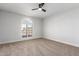 Bright bedroom with ceiling fan, carpeting, and arched window at 13903 W Gable Hill Dr, Sun City West, AZ 85375