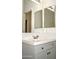 Bright bathroom with gray vanity, updated fixtures, and large mirror at 13915 N 132Nd Ln, Surprise, AZ 85379