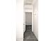 Simple hallway with light walls and gray tile floor at 13915 N 132Nd Ln, Surprise, AZ 85379