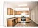 Modern kitchen with wood cabinets and stainless steel appliances at 13915 N 132Nd Ln, Surprise, AZ 85379