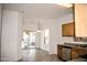 Kitchen with wood cabinets, stainless steel appliances, and view to backyard at 13915 N 132Nd Ln, Surprise, AZ 85379