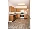 Open kitchen with wood cabinets and stainless steel appliances at 13915 N 132Nd Ln, Surprise, AZ 85379