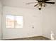 Bright living room with ceiling fan and wood-look floors at 13915 N 132Nd Ln, Surprise, AZ 85379