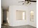 Bright living room with ceiling fan and wood-look floors at 13915 N 132Nd Ln, Surprise, AZ 85379