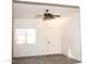 Bright living room with ceiling fan and wood-look floors at 13915 N 132Nd Ln, Surprise, AZ 85379