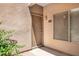Apartment entryway with brown door and window at 14145 N 92Nd St # 1052, Scottsdale, AZ 85260