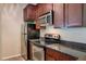 Kitchen with stainless steel appliances and dark wood cabinets at 14145 N 92Nd St # 1052, Scottsdale, AZ 85260