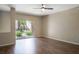 Living room with dark hardwood floors and sliding glass door to patio at 14145 N 92Nd St # 1052, Scottsdale, AZ 85260