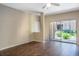 Living room with dark hardwood floors and sliding glass door to patio at 14145 N 92Nd St # 1052, Scottsdale, AZ 85260