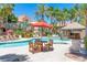 Community pool with patio tables and lounge chairs at 14145 N 92Nd St # 1052, Scottsdale, AZ 85260