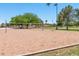 Outdoor sand volleyball court with net, surrounded by grass and trees at 14145 N 92Nd St # 1052, Scottsdale, AZ 85260