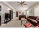 Open living room with brown sofas and a view of the kitchen at 14815 N Fountain Hills Blvd # 201, Fountain Hills, AZ 85268