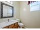 Bathroom features a mosaic mirror and white countertop at 14971 W Desert Hills Dr, Surprise, AZ 85379