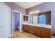 Double vanity bathroom with a large mirror and tile flooring at 14971 W Desert Hills Dr, Surprise, AZ 85379