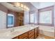 Double vanity bathroom with a large mirror and tile flooring at 14971 W Desert Hills Dr, Surprise, AZ 85379