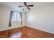 Bedroom with hardwood floors, window, and ceiling fan at 14971 W Desert Hills Dr, Surprise, AZ 85379