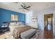 Spacious bedroom with wood floors and blue accent wall at 14971 W Desert Hills Dr, Surprise, AZ 85379