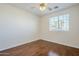 Well-lit bedroom featuring hardwood floors and a window at 14971 W Desert Hills Dr, Surprise, AZ 85379