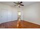 Hardwood floor bedroom with ceiling fan and access to loft at 14971 W Desert Hills Dr, Surprise, AZ 85379