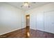 Bedroom with hardwood floors, ceiling fan, and double doors at 14971 W Desert Hills Dr, Surprise, AZ 85379