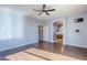 Bedroom with wood floors, access to bathroom and hallway at 14971 W Desert Hills Dr, Surprise, AZ 85379