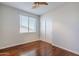 Bright bedroom with hardwood floors and ceiling fan at 14971 W Desert Hills Dr, Surprise, AZ 85379