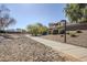 Paved pathway with desert landscaping, leading to residential homes at 14971 W Desert Hills Dr, Surprise, AZ 85379