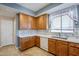 Kitchen corner with wood cabinets, white countertops and tile backsplash at 14971 W Desert Hills Dr, Surprise, AZ 85379