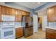 Kitchen with stainless steel appliances and wood cabinets at 14971 W Desert Hills Dr, Surprise, AZ 85379