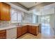 Kitchen with wood cabinets, white countertops and tile backsplash at 14971 W Desert Hills Dr, Surprise, AZ 85379