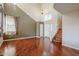 Two-story living room with hardwood floors and staircase at 14971 W Desert Hills Dr, Surprise, AZ 85379