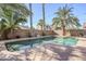 Inviting backyard pool with palm trees and string lights at 14971 W Desert Hills Dr, Surprise, AZ 85379