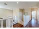 Upstairs hallway with hardwood floors and white railing at 14971 W Desert Hills Dr, Surprise, AZ 85379