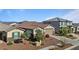 Two-story house with a two-car garage, landscaping and mountain views at 17838 W Gambit Trl, Surprise, AZ 85387