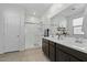 Bathroom with double vanity, shower, and linen closet at 17838 W Gambit Trl, Surprise, AZ 85387