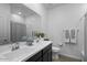 Double vanity bathroom with dark cabinetry and bathtub at 17838 W Gambit Trl, Surprise, AZ 85387