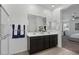 Double vanity bathroom with a view into the bedroom at 17838 W Gambit Trl, Surprise, AZ 85387