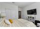 Bedroom with built-in shelving and large TV at 17838 W Gambit Trl, Surprise, AZ 85387