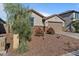 Single-story home with a two-car garage and nicely landscaped yard at 17838 W Gambit Trl, Surprise, AZ 85387