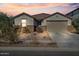 Single-story home with a two-car garage and landscaped front yard at 17838 W Gambit Trl, Surprise, AZ 85387